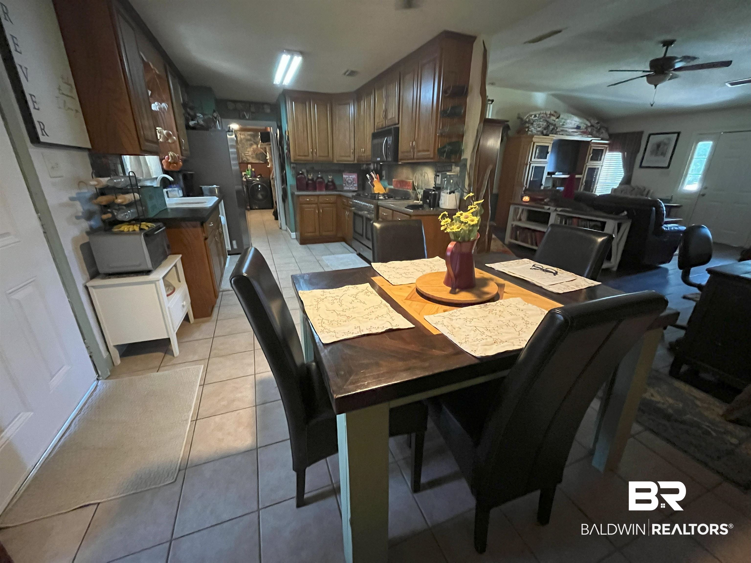 7851 Highway 98 Fairhope, AL 36532 - Photo 16 of 40 Dining space with light tile patterned floors and ceiling fan