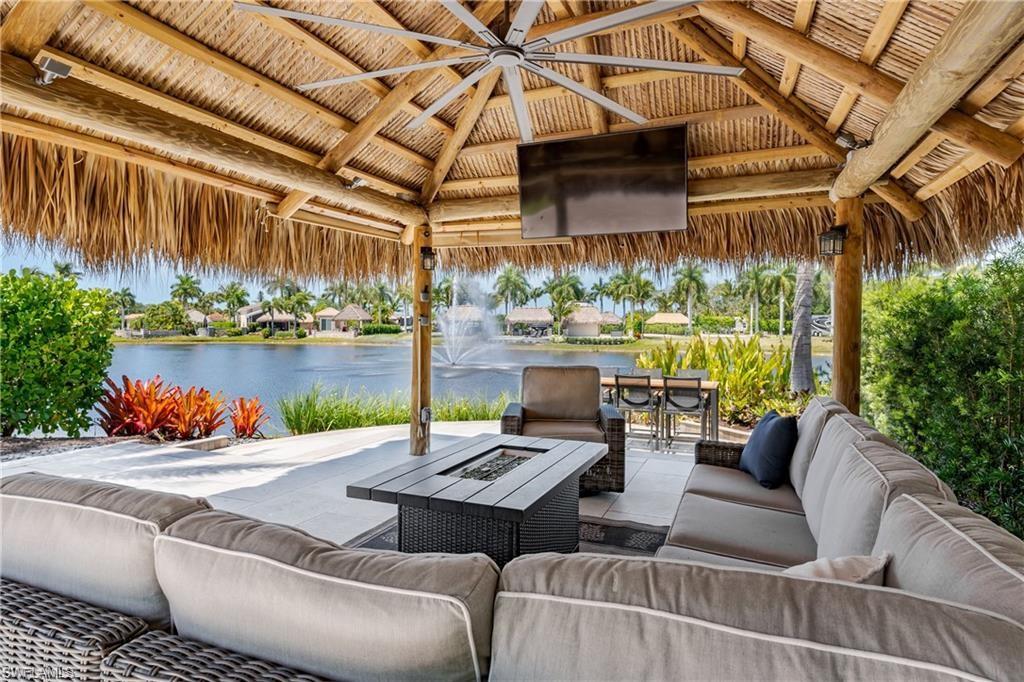 13461 Ladyfish Lane Naples, FL 34114 - Photo 11 of 30 a view of a patio with couches table and chairs with potted plants