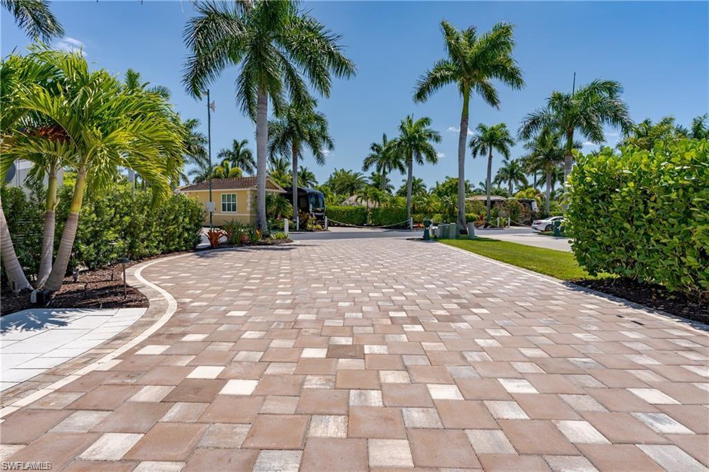 13461 Ladyfish Lane Naples, FL 34114 - Photo 12 of 30 a front view of a house with a garden