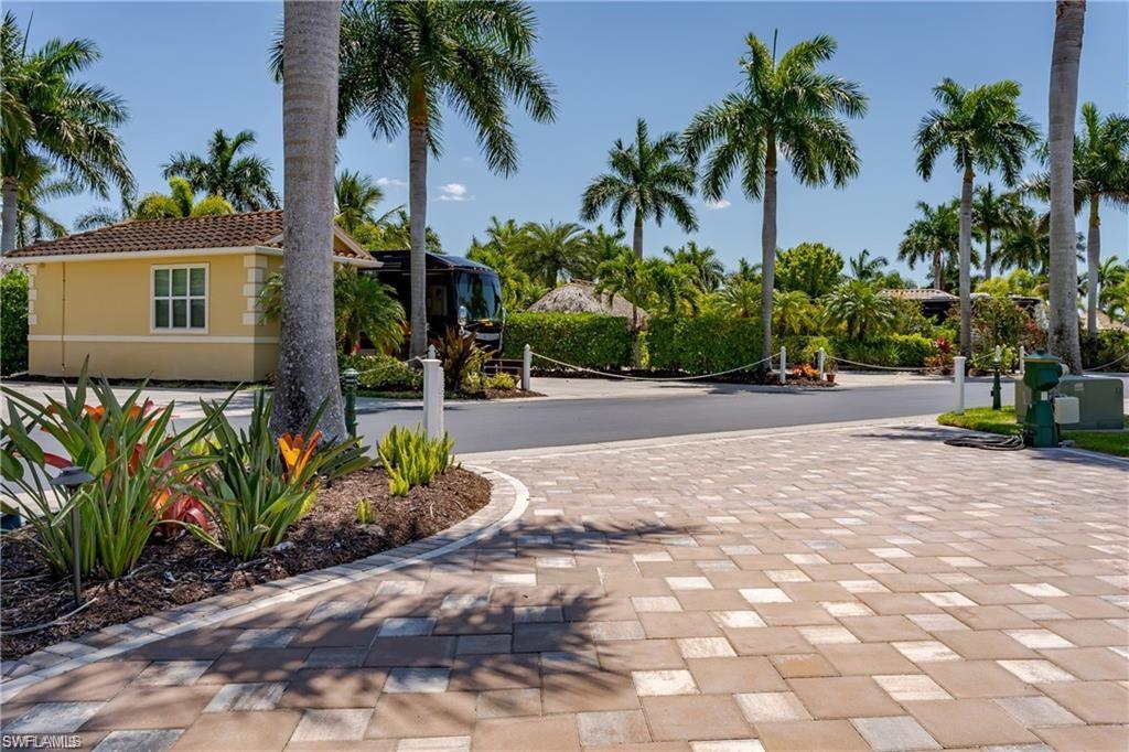 13461 Ladyfish Lane Naples, FL 34114 - Photo 15 of 30 a front view of a house with a garden