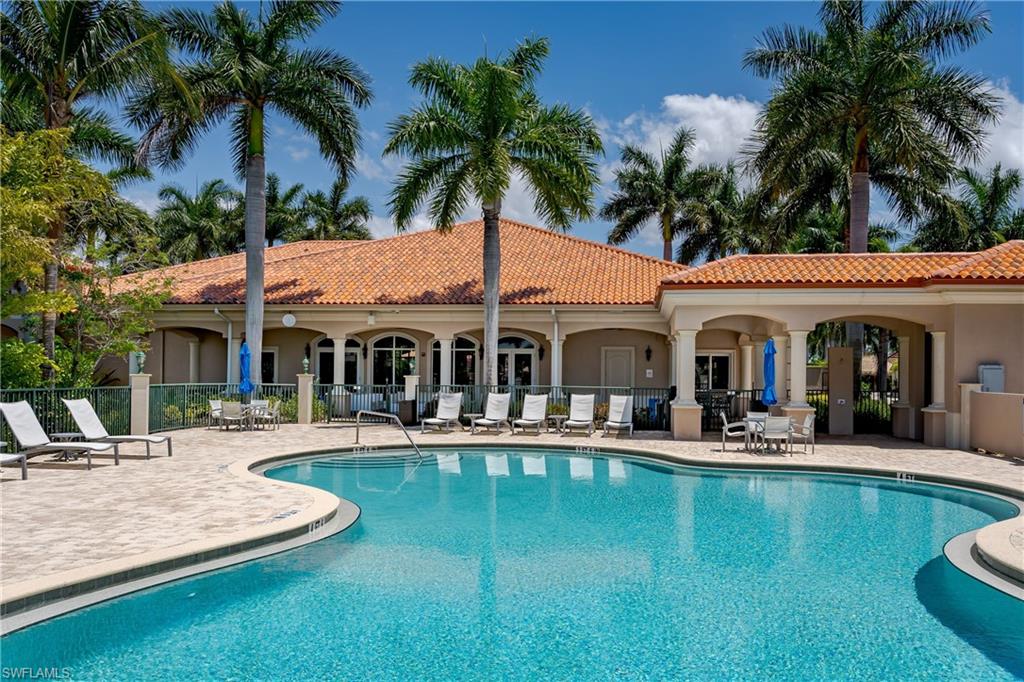 13461 Ladyfish Lane Naples, FL 34114 - Photo 23 of 30 a view of a swimming pool with a table and chairs