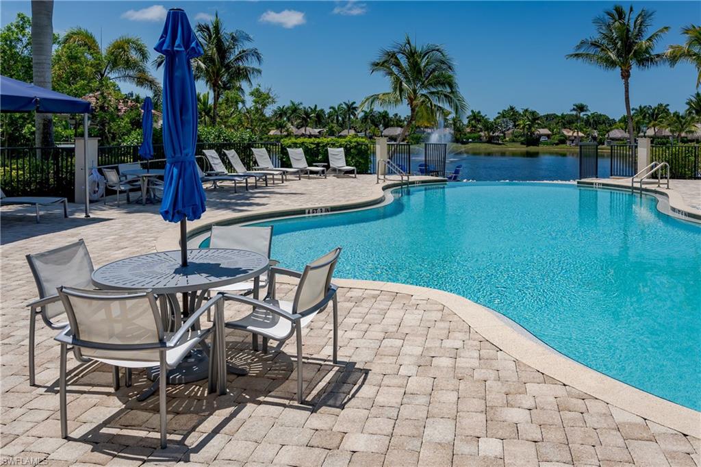 13461 Ladyfish Lane Naples, FL 34114 - Photo 24 of 30 a swimming pool with outdoor seating and yard