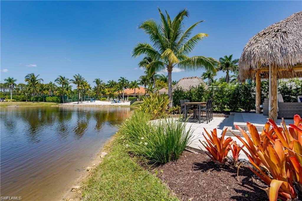 13461 Ladyfish Lane Naples, FL 34114 - Photo 3 of 30 a view of a swimming pool with a table and chairs