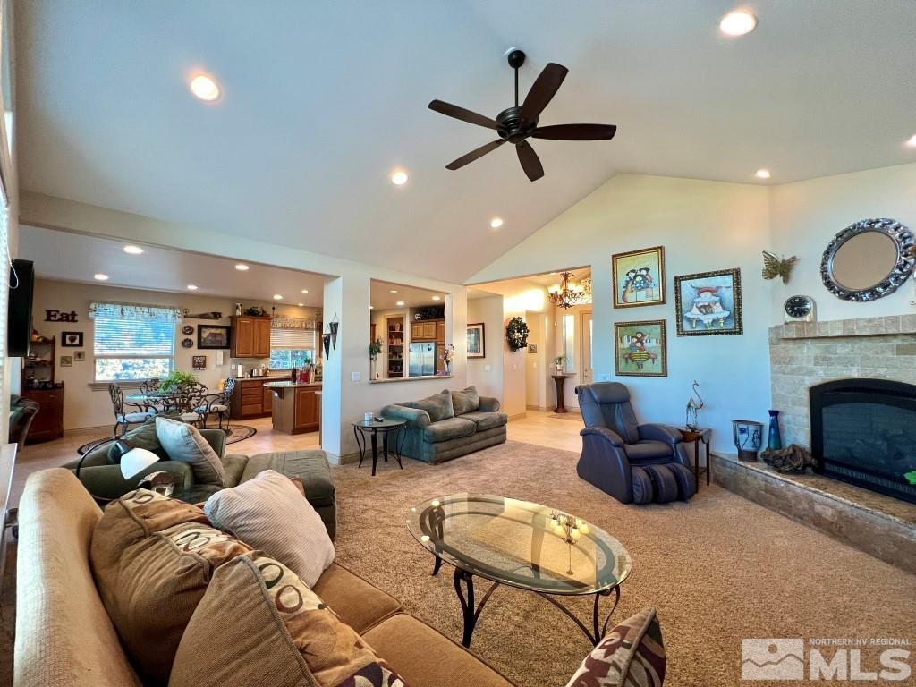 4960 Gila Bend Road Reno, NV 89511 - Photo 10 of 33 a living room with furniture a fireplace and a view of kitchen