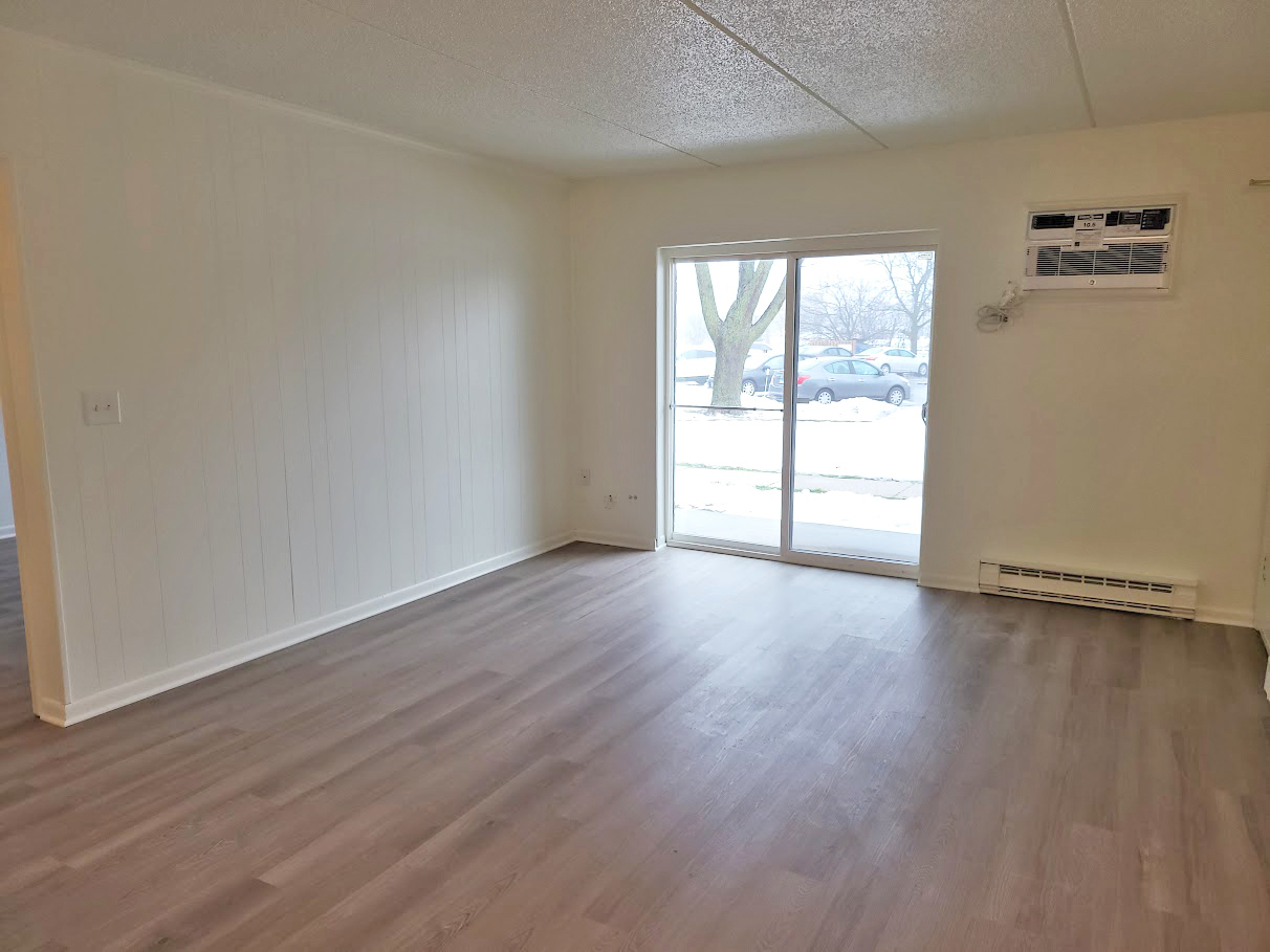 945 North Rohlwing Road, Unit GM Addison, IL 60101 - Photo 4 of 14 an empty room with wooden floor and windows