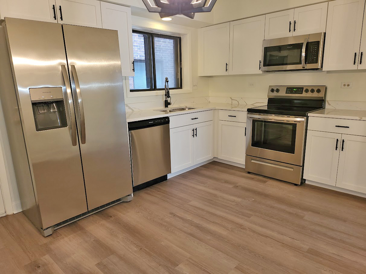 945 North Rohlwing Road, Unit GM Addison, IL 60101 - Photo 7 of 14 a kitchen with stainless steel appliances kitchen island granite countertop a stove a sink and a refrigerator