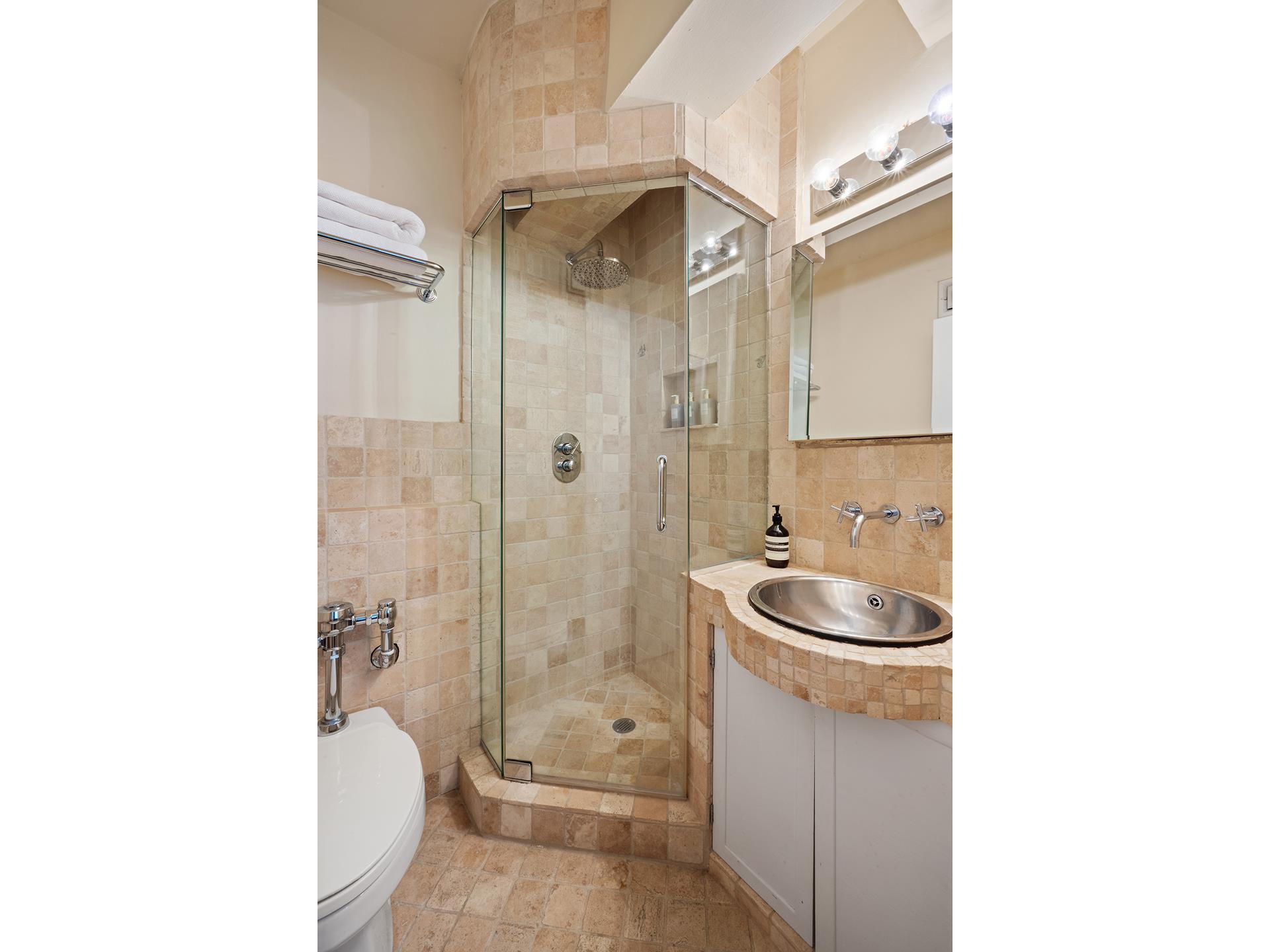 45 West 54th Street, Unit 11/12A Manhattan, NY 10019 - Photo 14 of 18 a bathroom with a toilet a sink and a bathtub