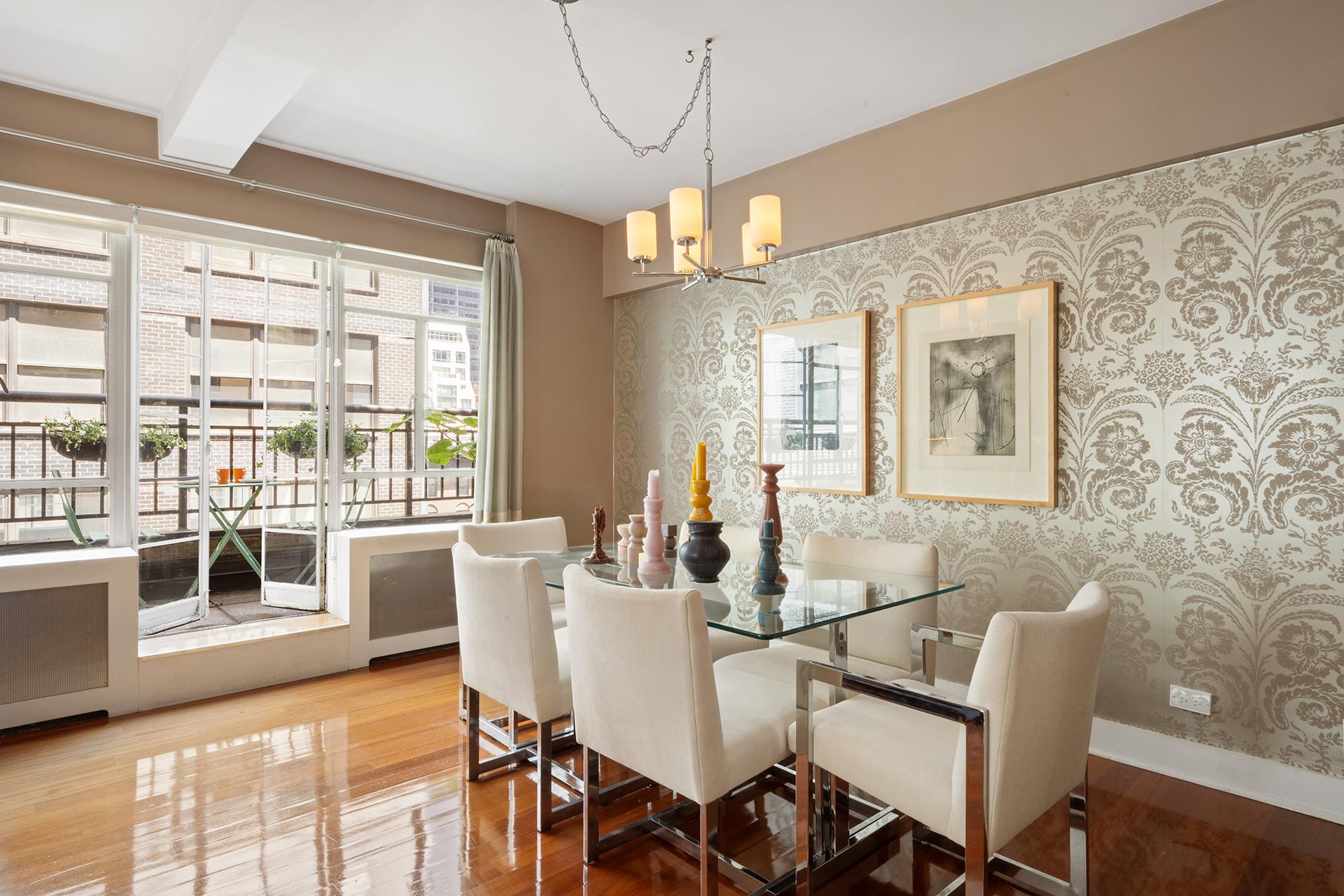 45 West 54th Street, Unit 11/12A Manhattan, NY 10019 - Photo 16 of 18 a view of a dining room with furniture and wooden floor