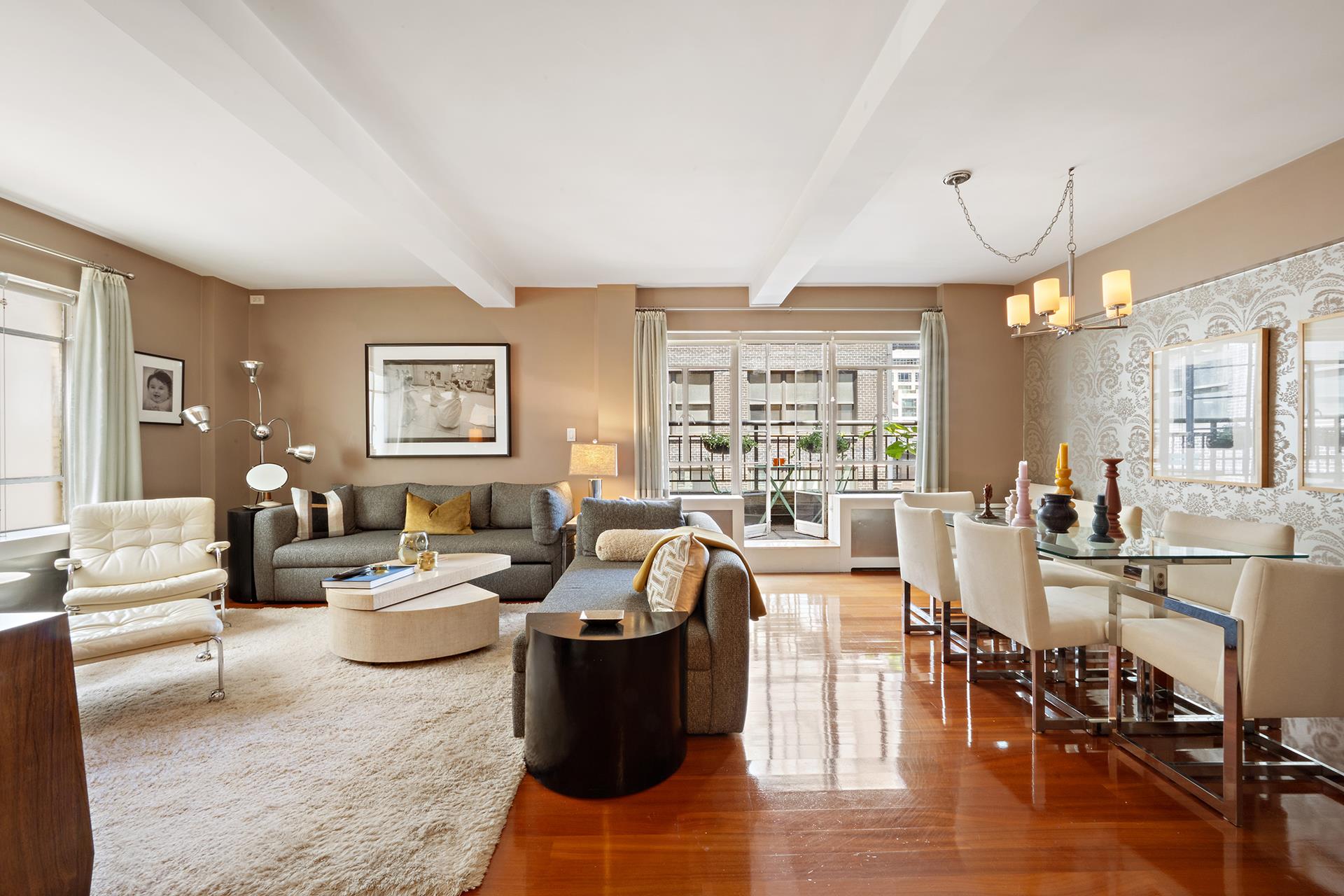 45 West 54th Street, Unit 11/12A Manhattan, NY 10019 - Photo 2 of 18 a living room with lots of furniture and a large window