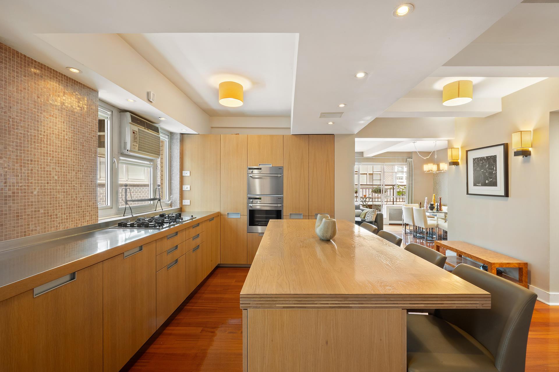 45 West 54th Street, Unit 11/12A Manhattan, NY 10019 - Photo 6 of 18 a large dining hall with stainless steel appliances granite countertop a sink and dining table view