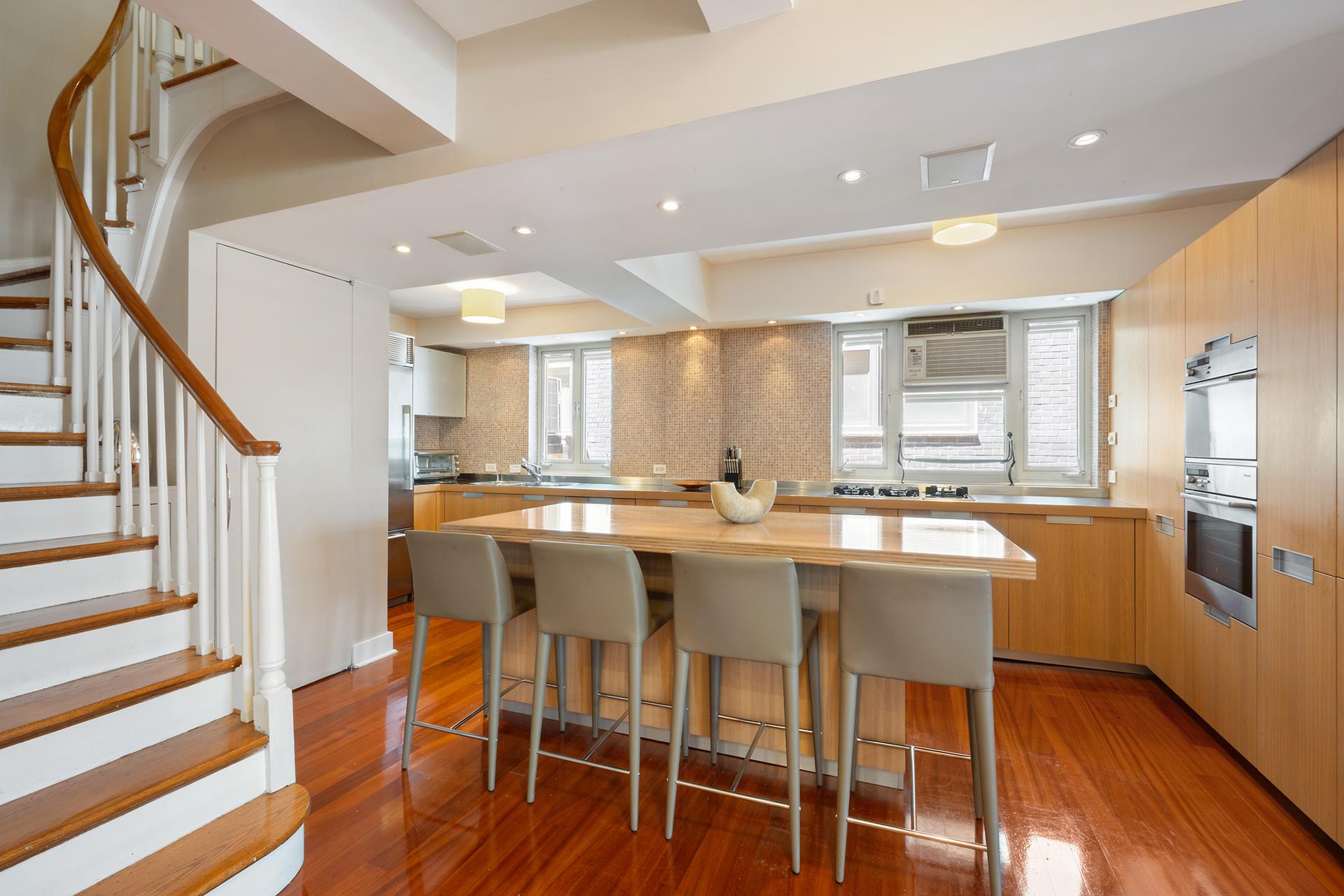 45 West 54th Street, Unit 11/12A Manhattan, NY 10019 - Photo 7 of 18 a dining hall with stainless steel appliances granite countertop a dining table chairs and granite counter tops