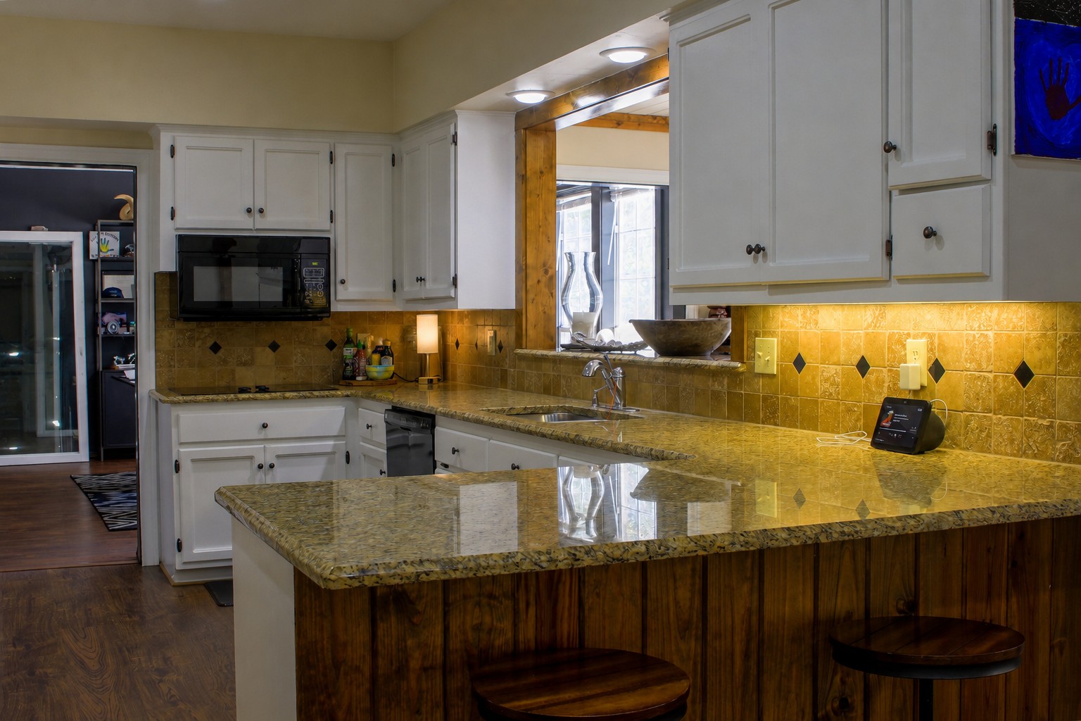 405 Frederick Road Fredericksburg, TX 78624 - Photo 9 of 29 Granite counters complement this well-appointed kitchen, ready for culinary endeavors.