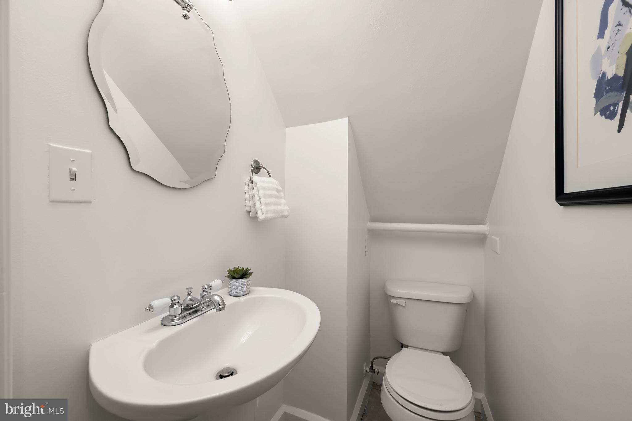 2805 Olive Street Northwest Washington, DC 20007 - Photo 18 of 30 a bathroom with a toilet sink and mirror