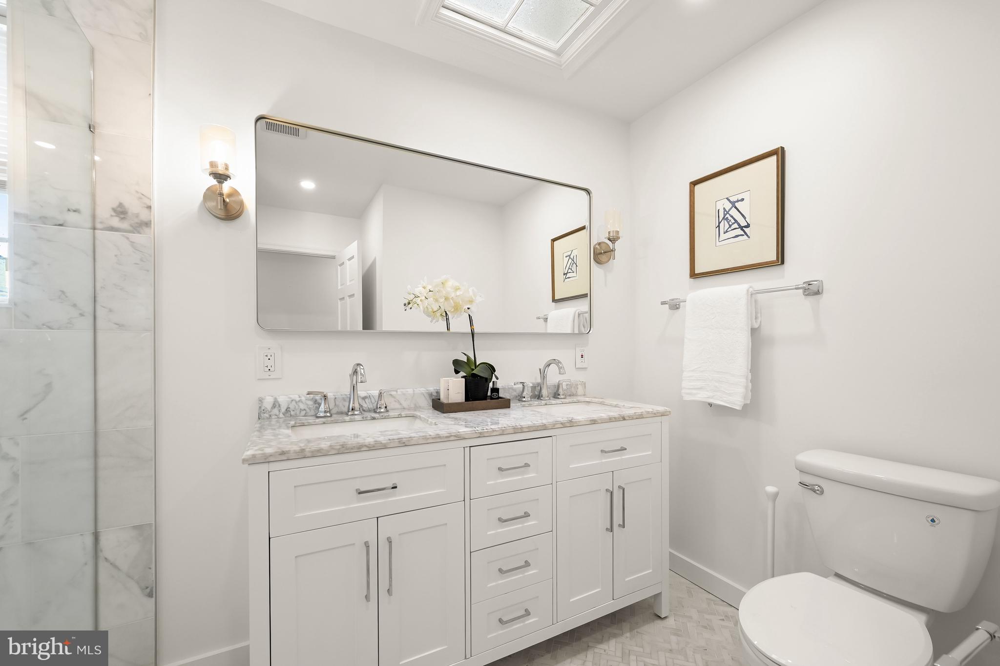 2805 Olive Street Northwest Washington, DC 20007 - Photo 21 of 30 a bathroom with a granite countertop toilet sink and a mirror