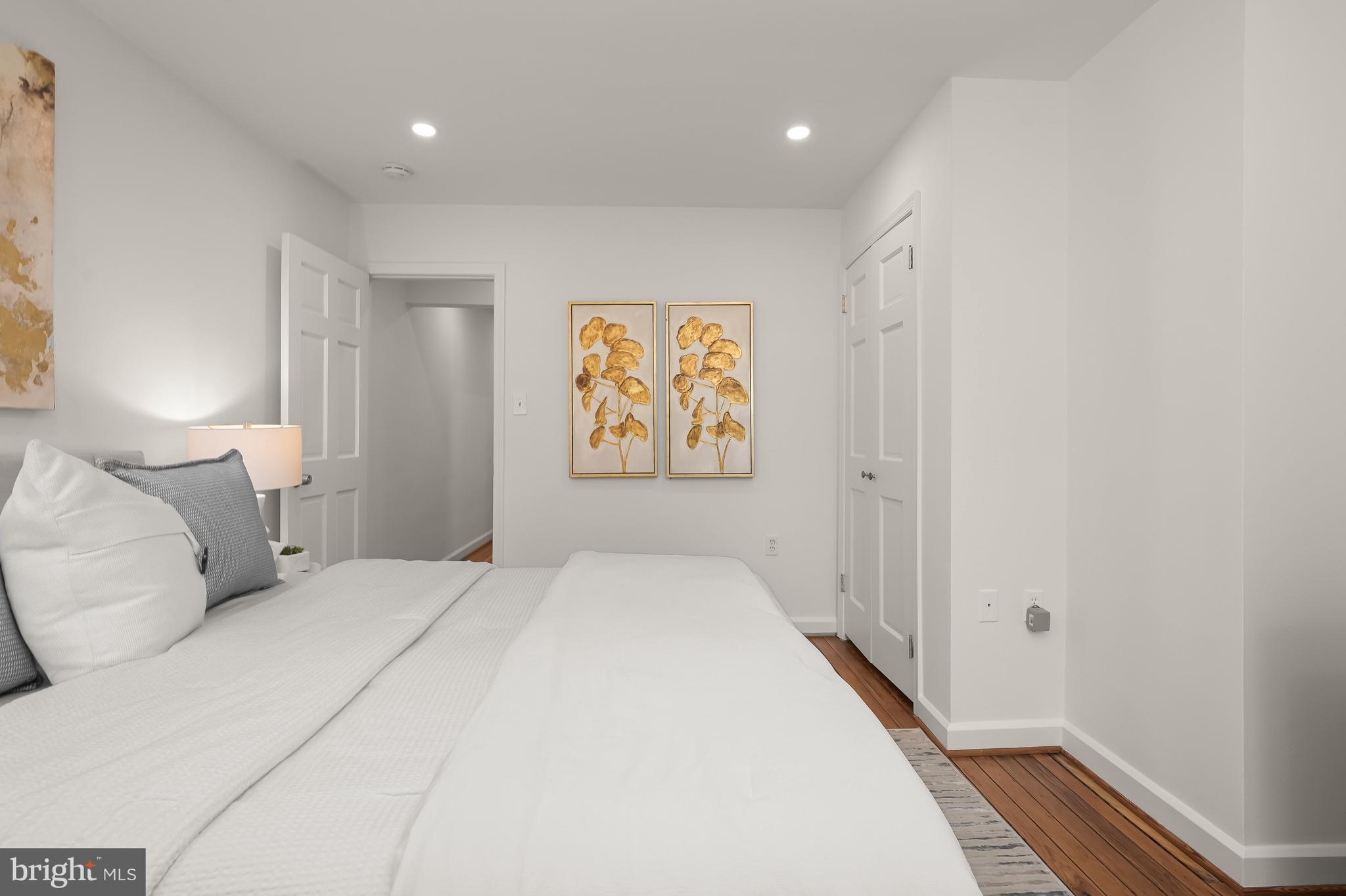 2805 Olive Street Northwest Washington, DC 20007 - Photo 27 of 30 a bedroom with a large bed and a painting on the wall
