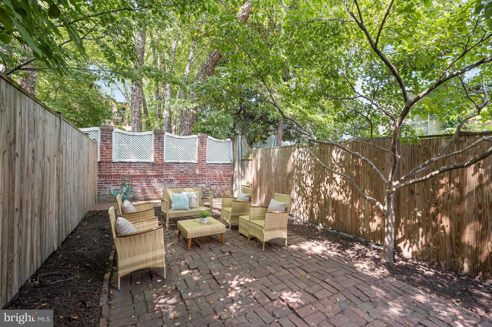 2805 Olive Street Northwest Washington, DC 20007 - Photo 4 of 30 a view of a patio with table and chairs and wooden fence