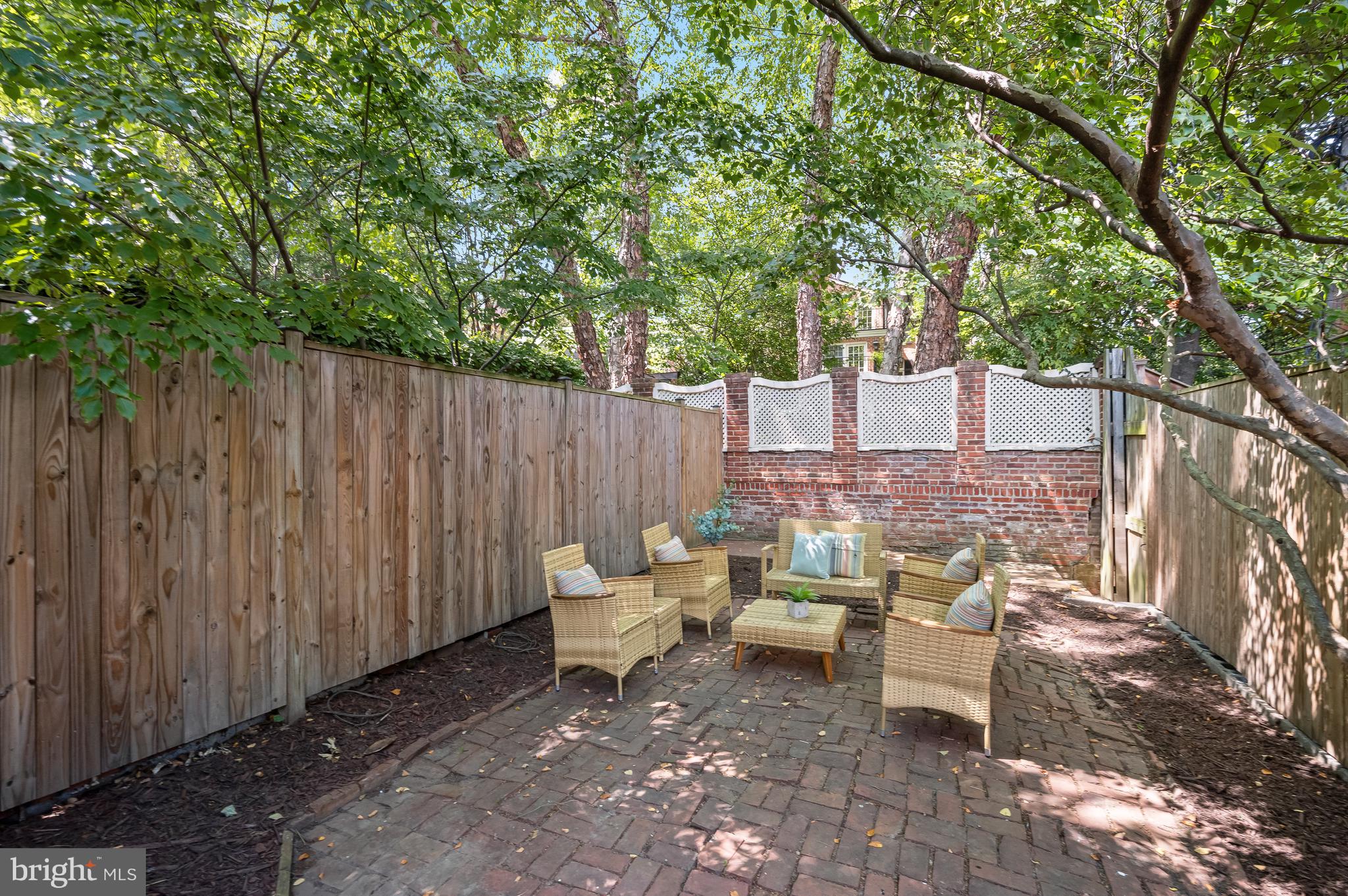 2805 Olive Street Northwest Washington, DC 20007 - Photo 6 of 30 a view of backyard with table and chairs and a large tree
