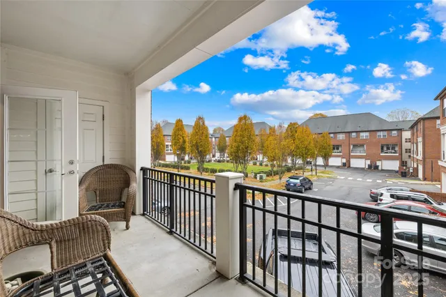 a view of a chair and tables in the balcony