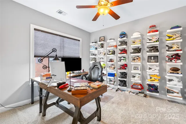 a work room with furniture and a flat screen tv