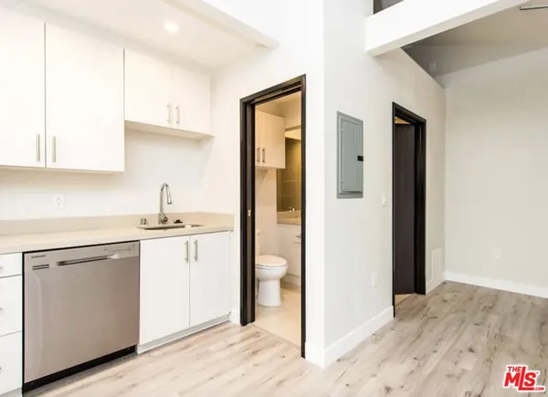 a kitchen with a sink cabinets and a refrigerator