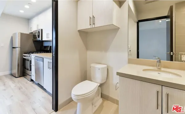 a bathroom with a toilet sink and mirror