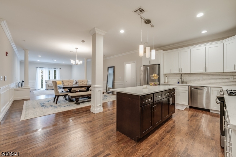 a kitchen with a stove a sink and a refrigerator