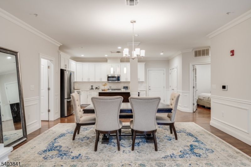 231 River Road, Unit 231 Somerville, NJ 08876 - Photo 12 of 31 a view of a dining room with furniture and wooden floor