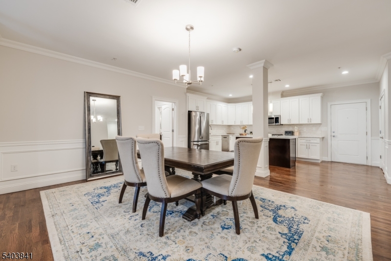 231 River Road, Unit 231 Somerville, NJ 08876 - Photo 13 of 31 a view of a dining room with furniture and wooden floor