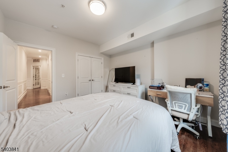 231 River Road, Unit 231 Somerville, NJ 08876 - Photo 21 of 31 a bedroom with a bed and a flat screen tv