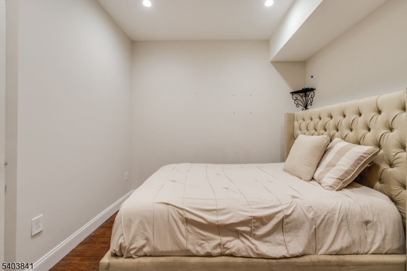 231 River Road, Unit 231 Somerville, NJ 08876 - Photo 26 of 31 a bedroom with a bed and a mirror