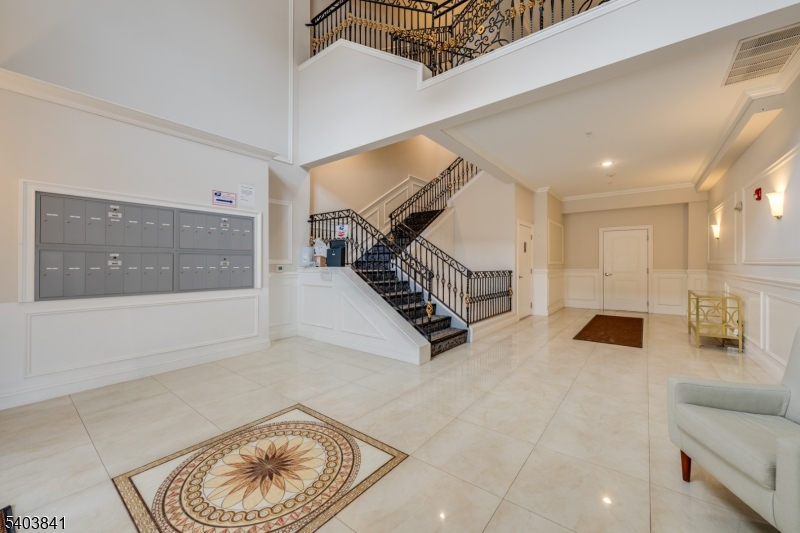 231 River Road, Unit 231 Somerville, NJ 08876 - Photo 5 of 31 a living room with furniture and stairs