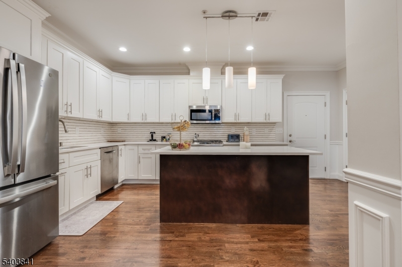 231 River Road, Unit 231 Somerville, NJ 08876 - Photo 8 of 31 a kitchen with kitchen island granite countertop a sink cabinets and stainless steel appliances