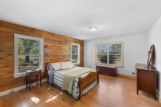 a bedroom with a bed and large window