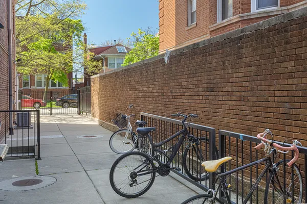 a view of a patio with table and chairs with wooden floor and fence