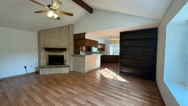 a view of a kitchen with wooden cabinet and a fireplace