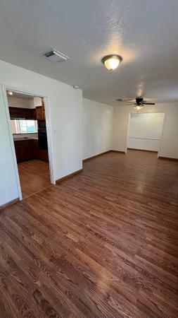 a view of an empty room and wooden floor