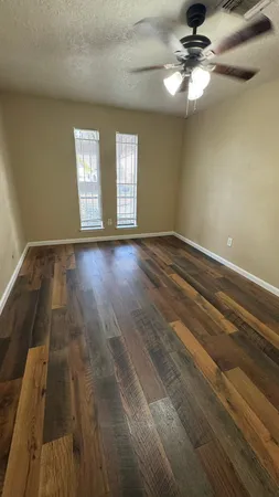 wooden floor in an empty room with a window