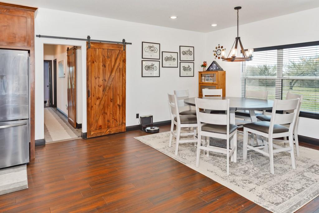 217 Polk Road Bowie, TX 76230 - Photo 13 of 39 a view of a dining room with furniture window and wooden floor