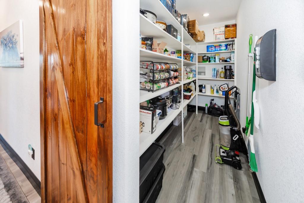 217 Polk Road Bowie, TX 76230 - Photo 20 of 39 a view of walk in closet with clothes and shoes