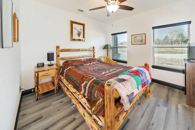 a bedroom with a bed and a chandelier