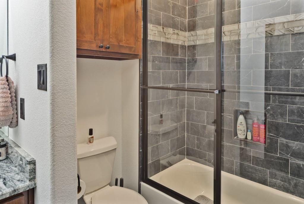 217 Polk Road Bowie, TX 76230 - Photo 23 of 39 a bathroom with a shower and toilet
