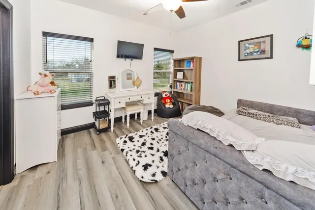 a bedroom with furniture and a window