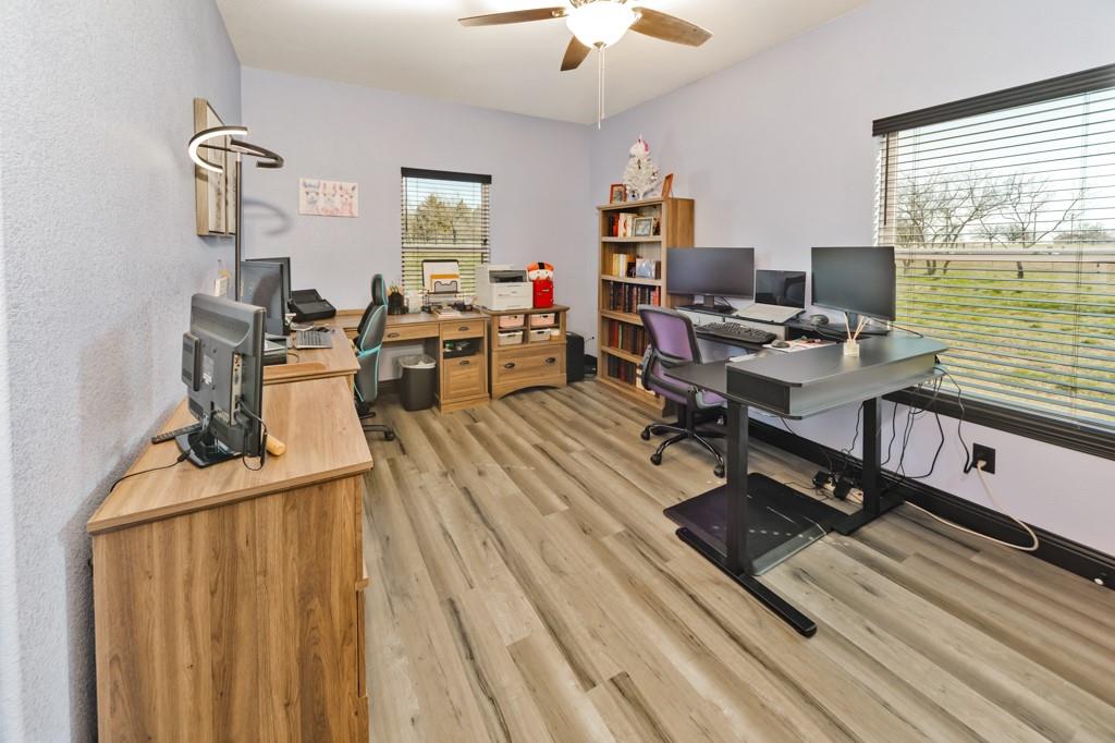 217 Polk Road Bowie, TX 76230 - Photo 28 of 39 a workspace with wooden floor and a window
