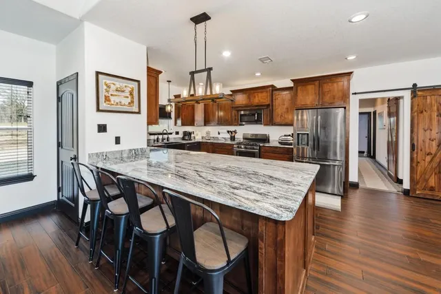 a large kitchen with a table and chairs