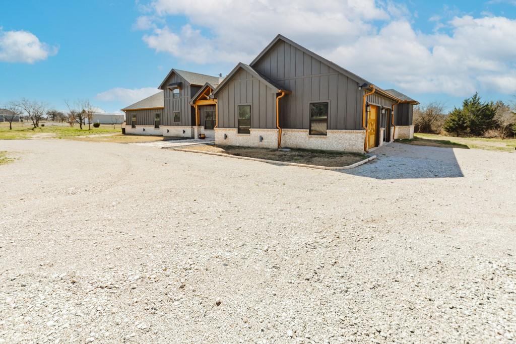 217 Polk Road Bowie, TX 76230 - Photo 32 of 39 a view of a house with a yard covered with snow in the background
