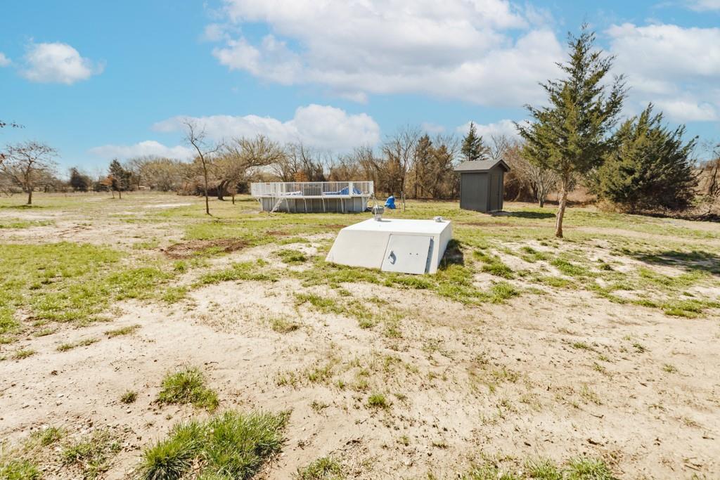 217 Polk Road Bowie, TX 76230 - Photo 37 of 39 a view of a yard with an trees