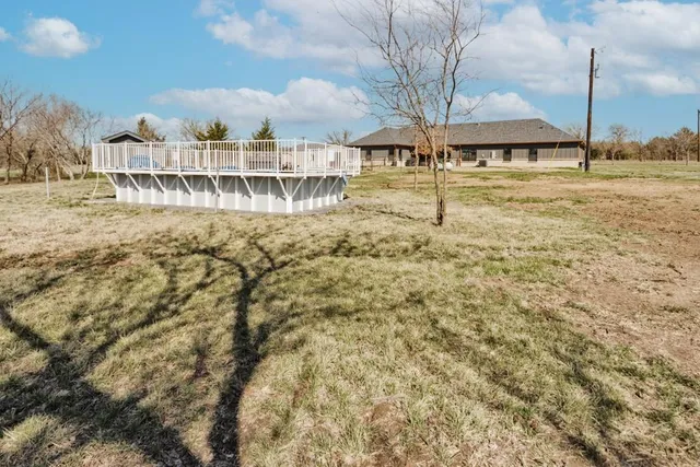 a view of a swimming pool with a yard