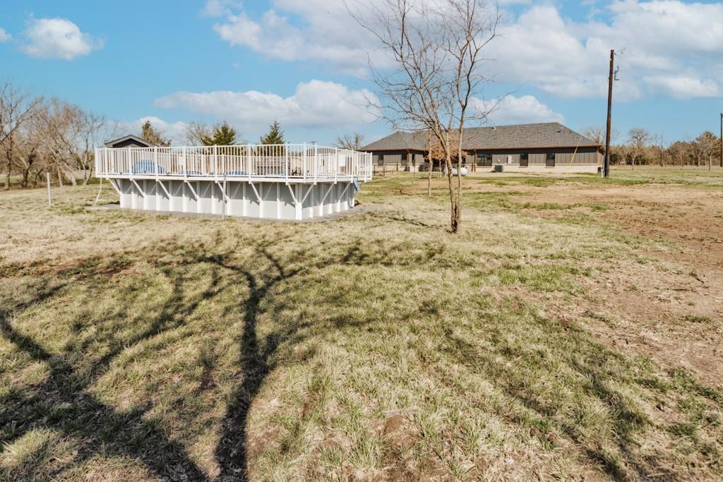 217 Polk Road Bowie, TX 76230 - Photo 39 of 39 a view of a swimming pool with a yard