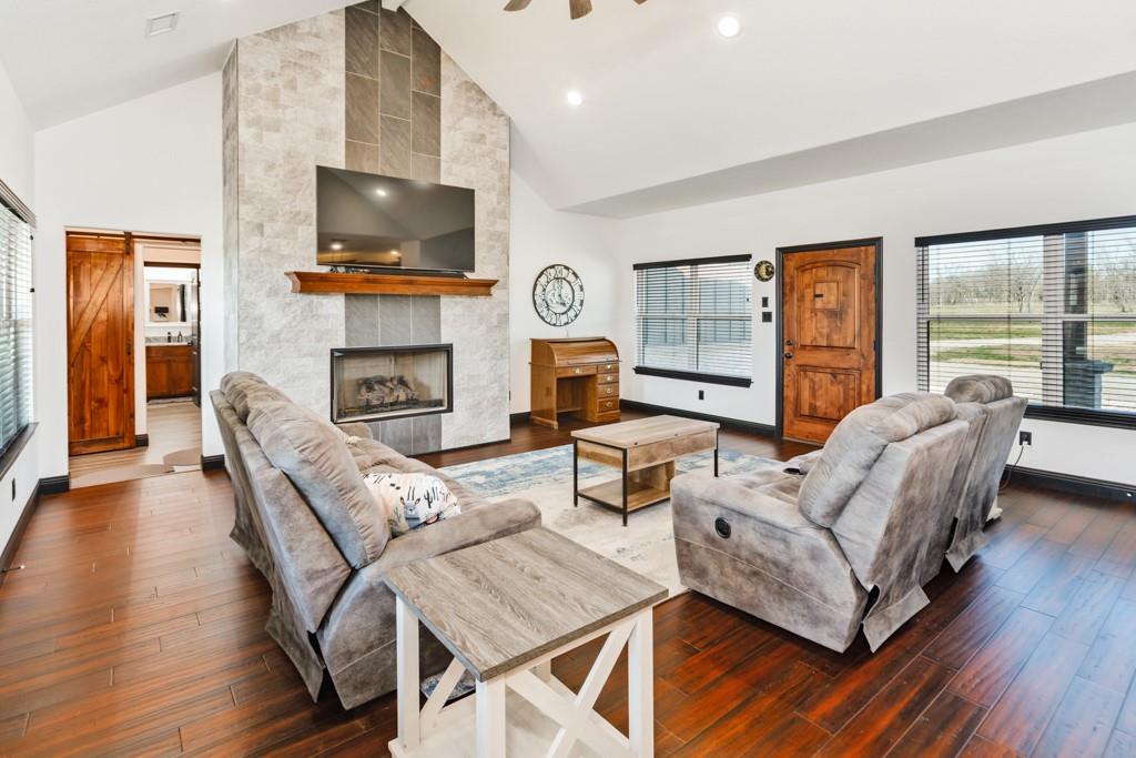 217 Polk Road Bowie, TX 76230 - Photo 8 of 39 a living room with fireplace furniture and a flat screen tv