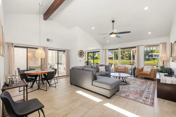 a living room with furniture and large windows